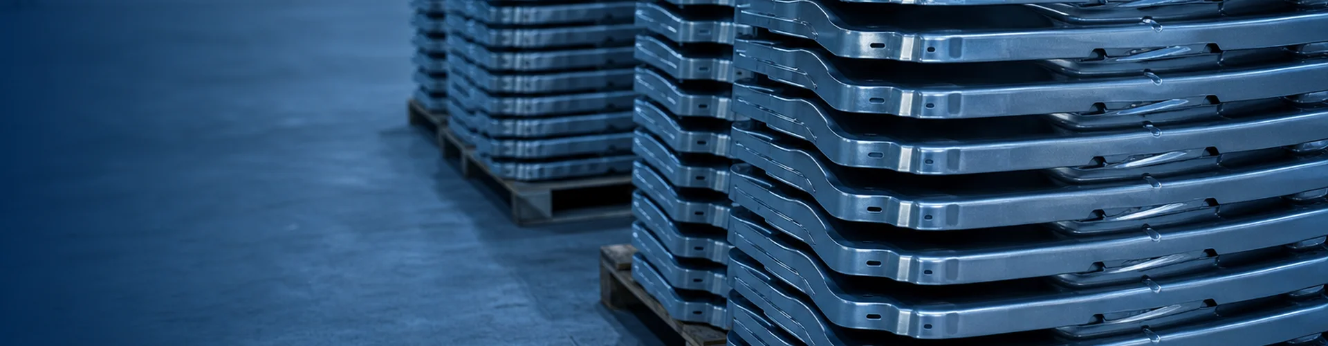 Stacks of identical stamped steel parts palletized in the Ping Fang workshop